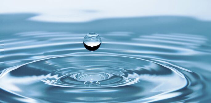A mesmerizing shot of a water droplet capturing the beauty of liquid dynamics.